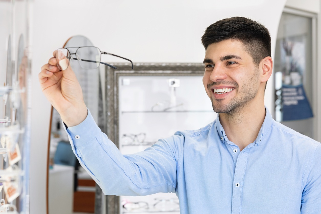A guy choosing prescription glasses