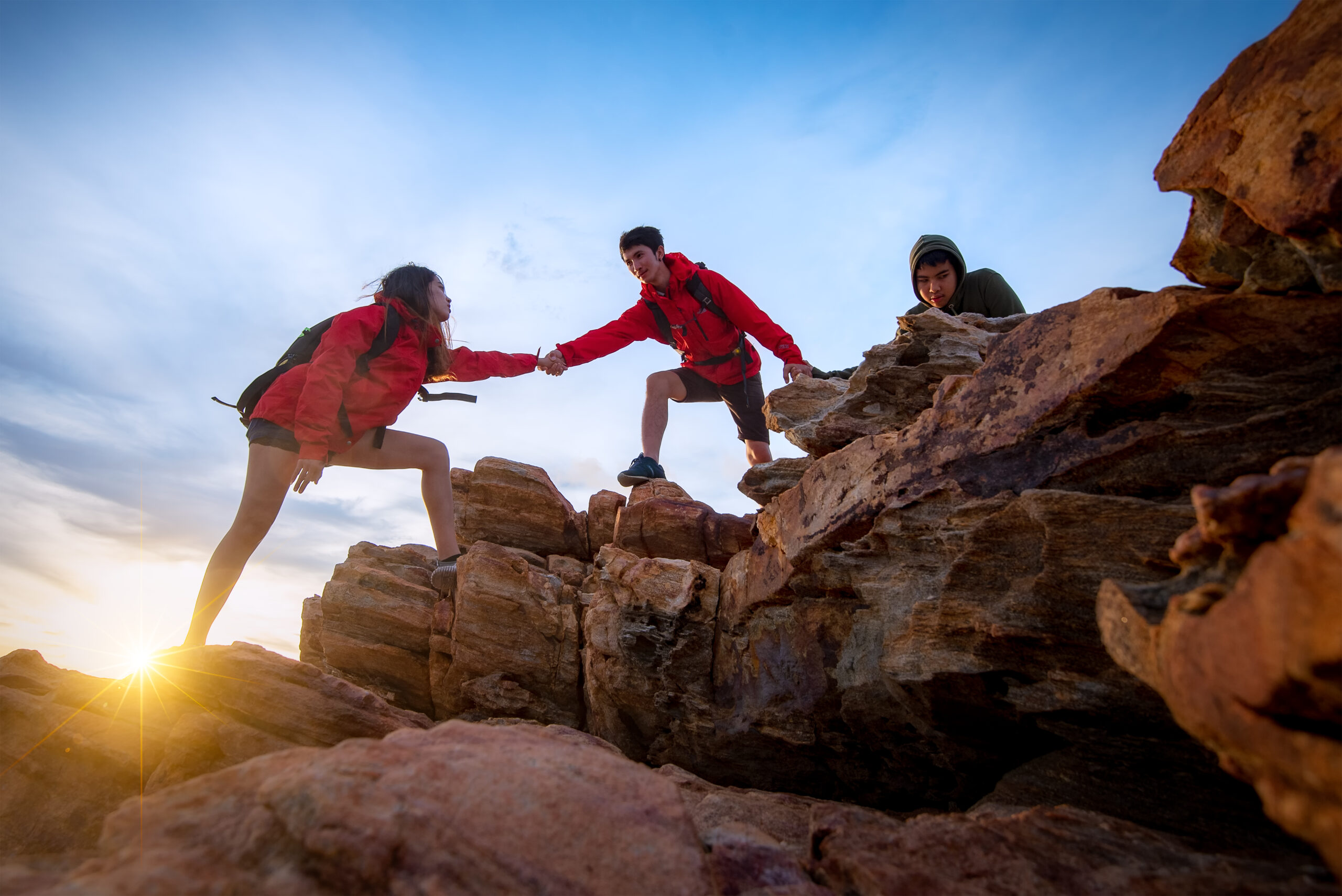 A group of mountain climbers climbing up a mountain