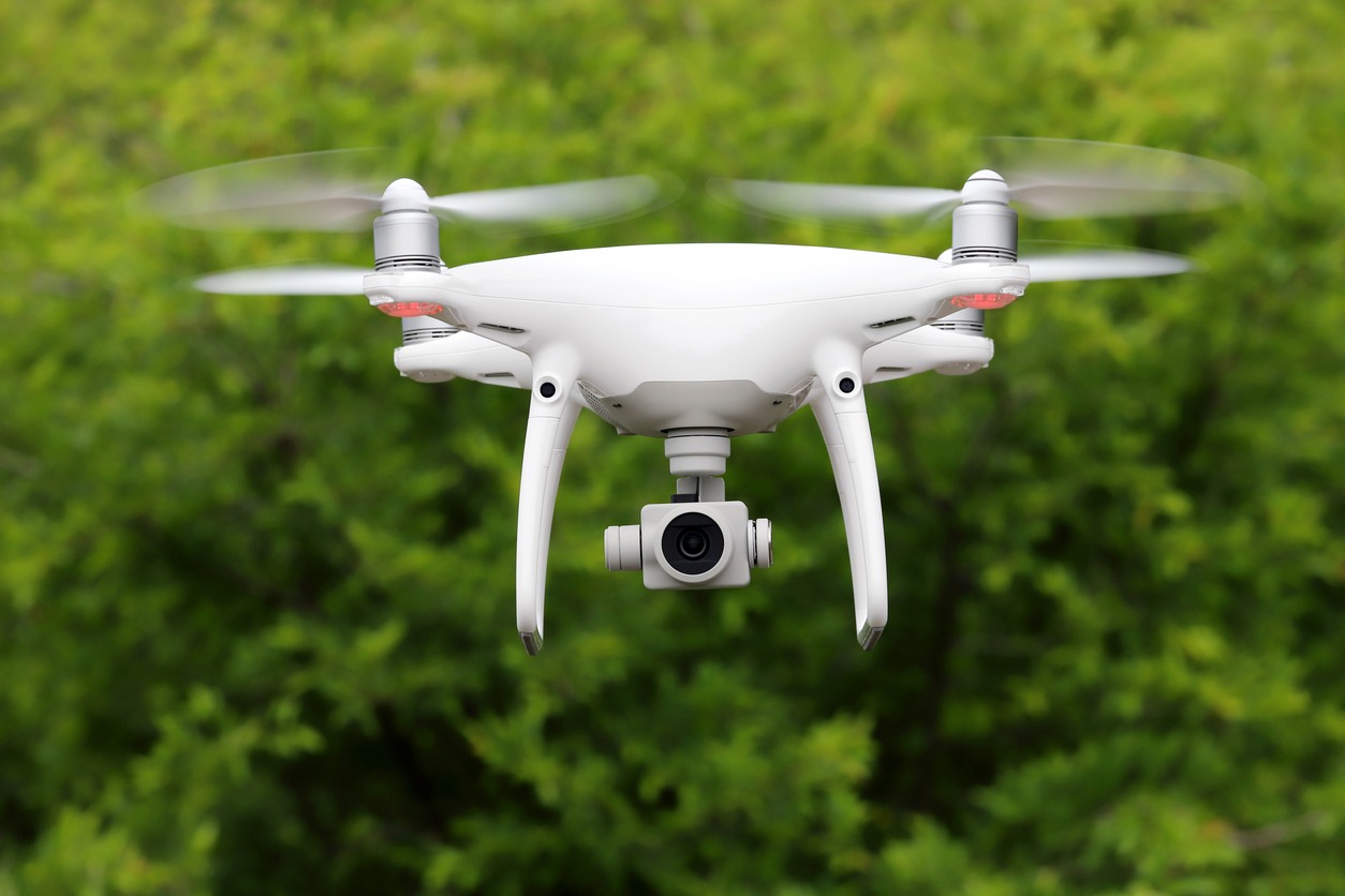 A drone flying amongst trees