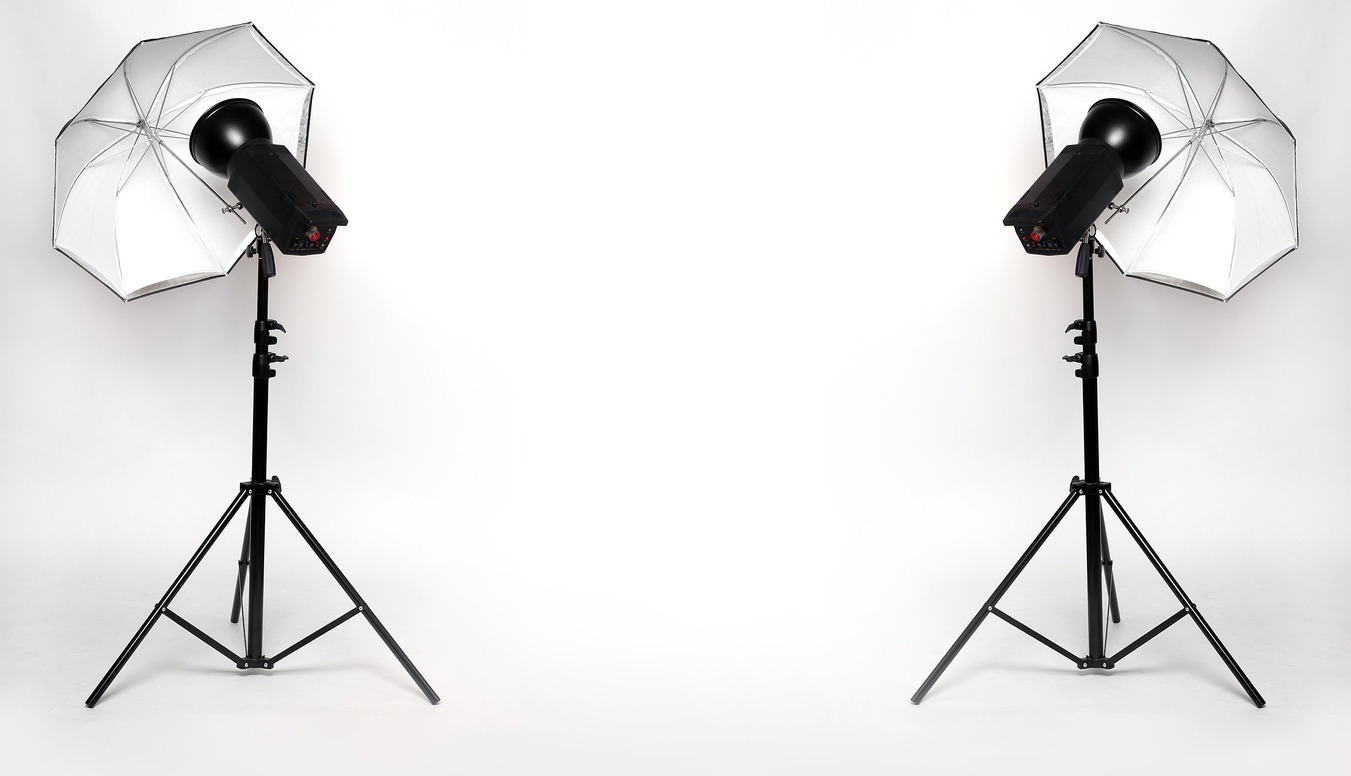 pair of strobe lights with umbrellas
