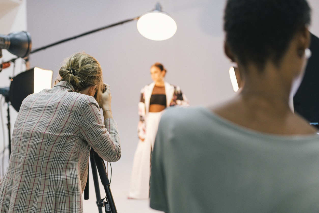 photographer capturing a model in 3-point lighting setup