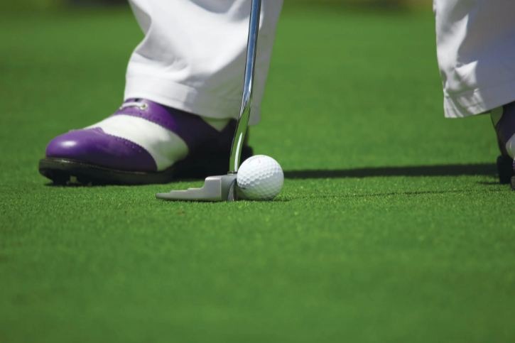 person-in-white-pants-playing-golf