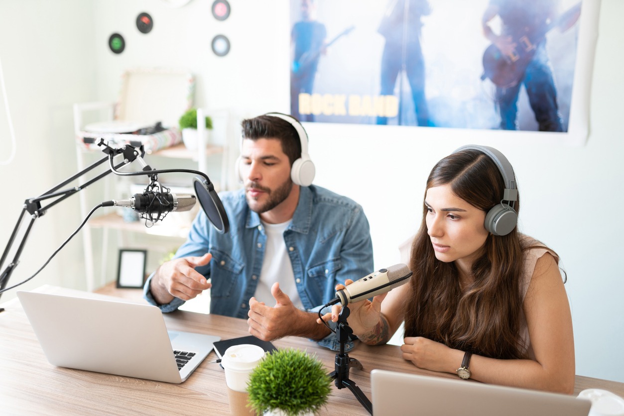 a man and woman co-hosting a podcast