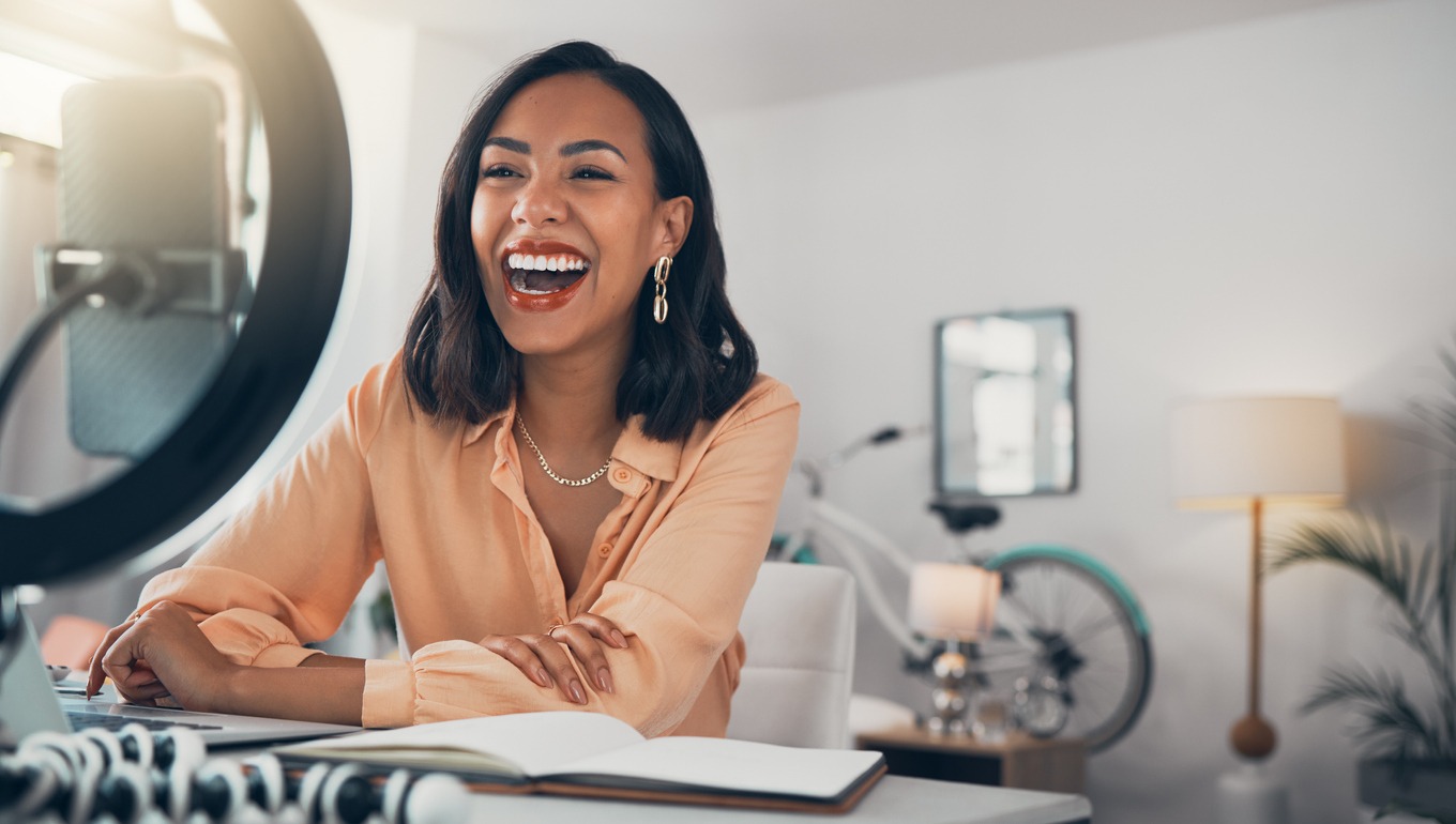 a woman happily talking to her online followers