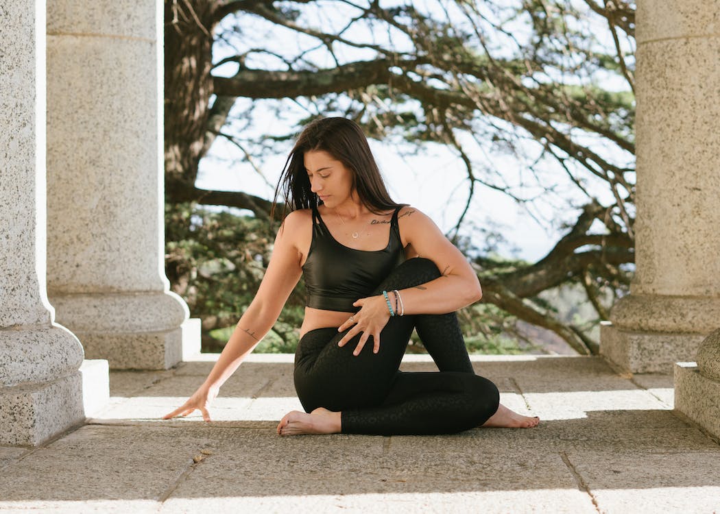 A woman performing the gomukhasana pose