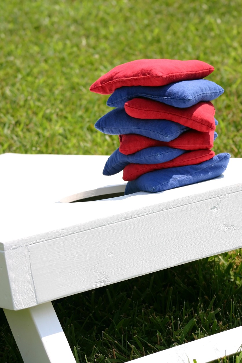 Cornhole bags stacked on a board