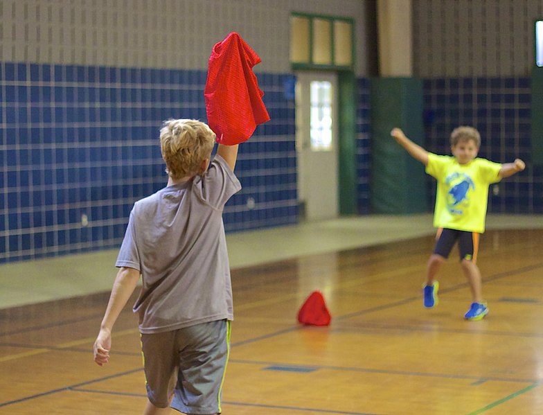 Boys playing capture the flag indoors