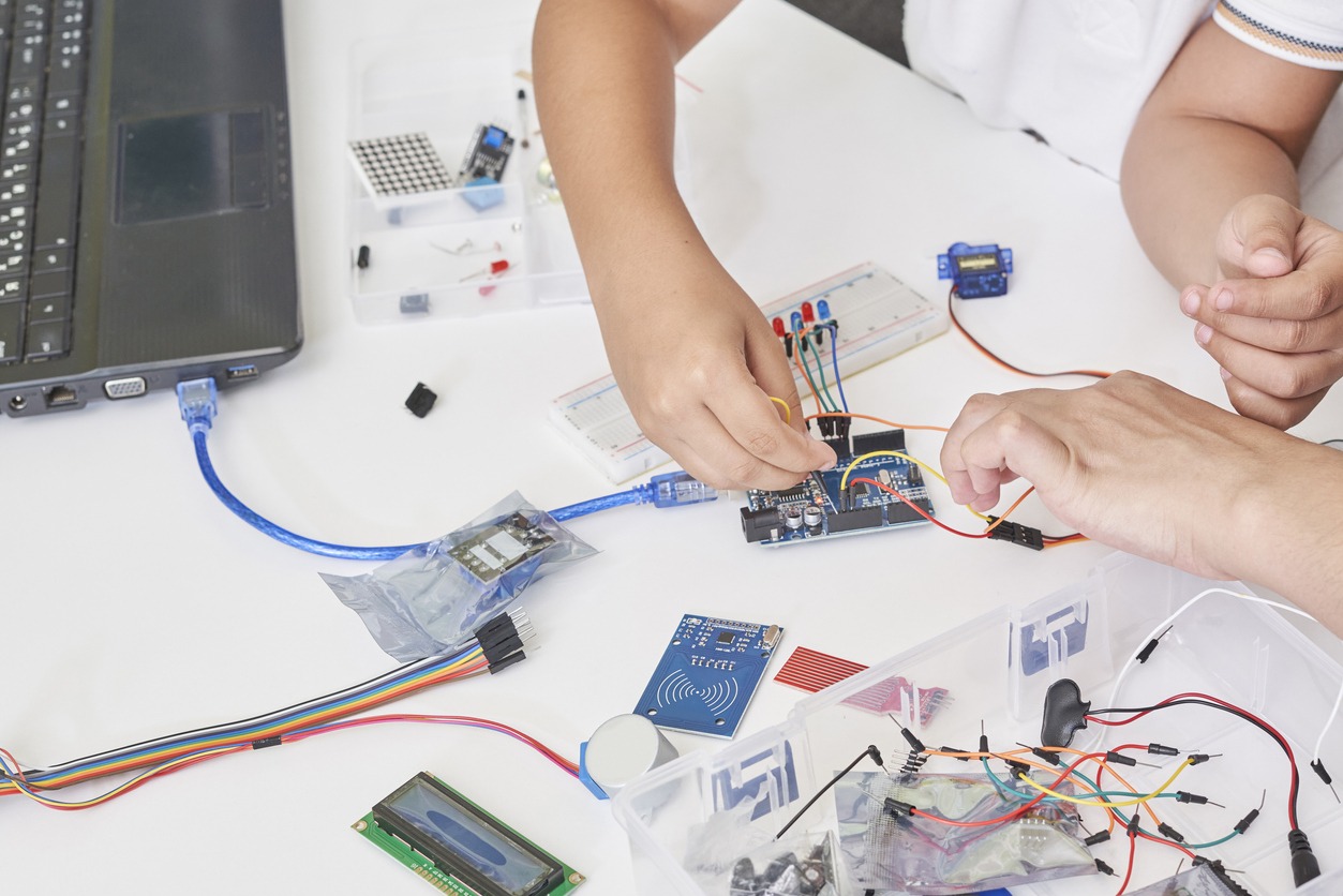 students programming a robot during STEM education class