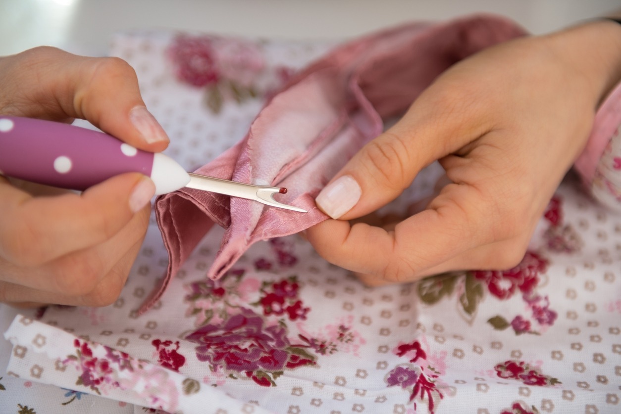 closeup on seamstress unthread