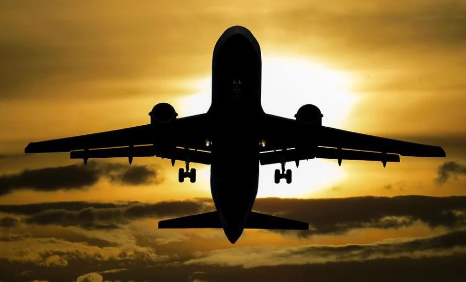airplane flying during the sunset