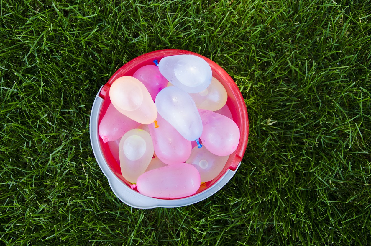 Water balloons in a bucket on grass