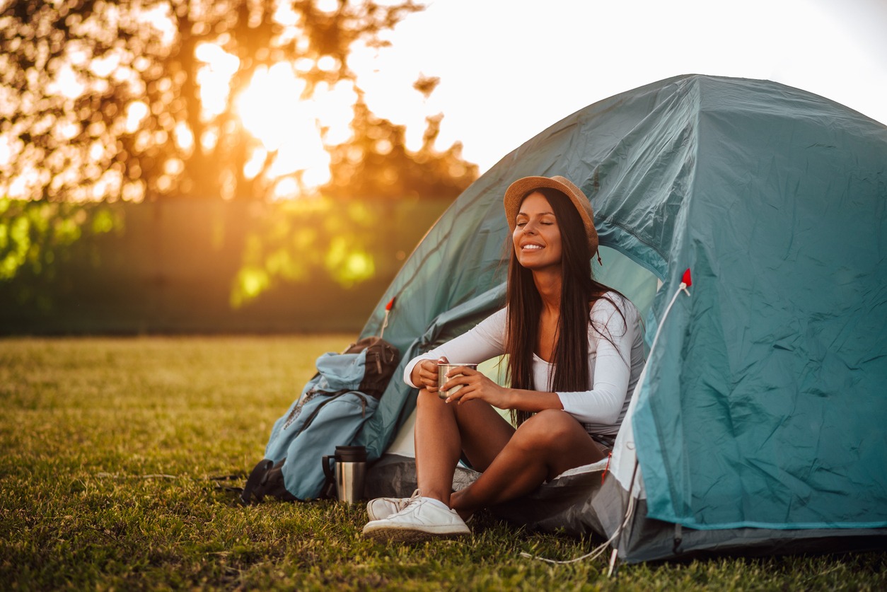 A woman relaxing inside camping tent