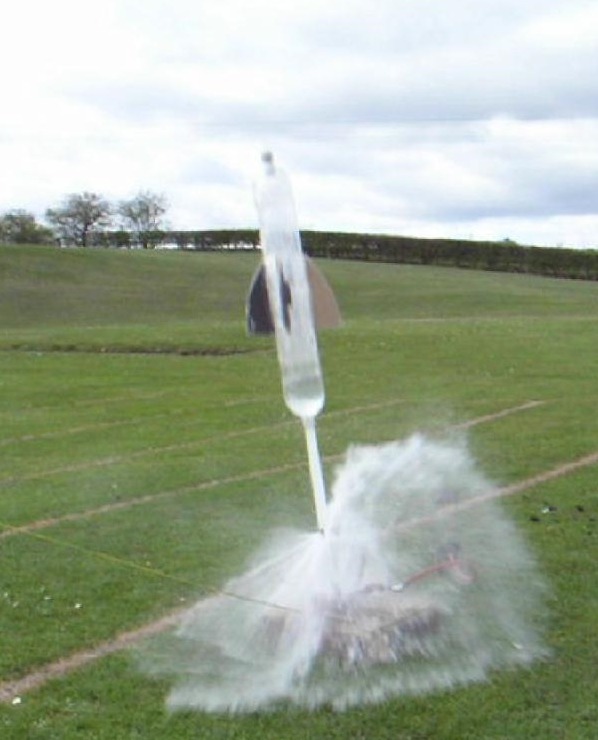 water rocket launching off a field