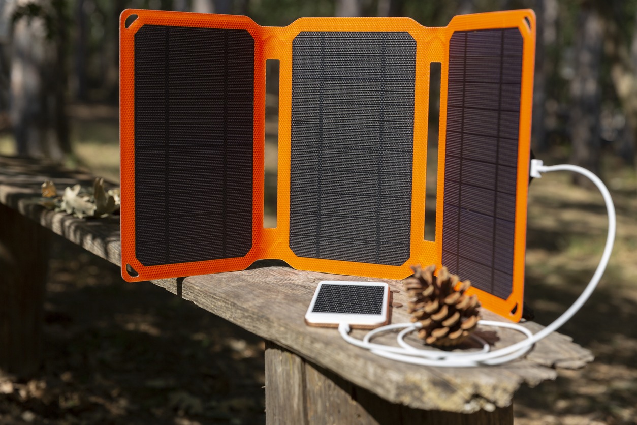 smartphone is charging from a solar battery
