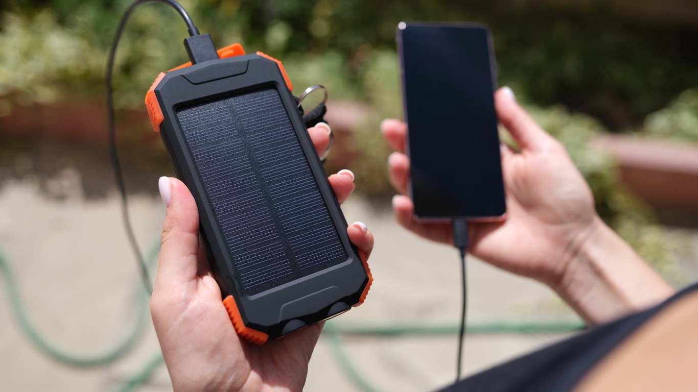 solar power bank charging a phone