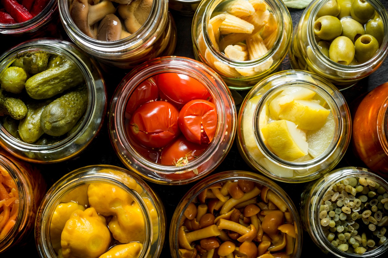 Preserved vegetables in glass jars. Top view