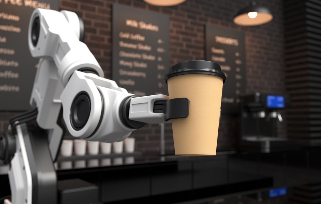 Robotic arm handing out coffee at a cafe