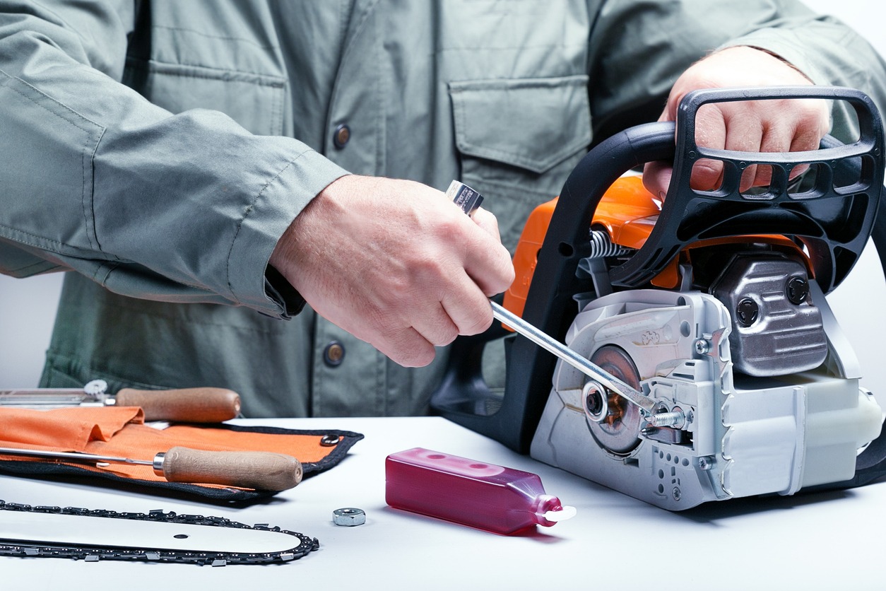 Man repairing a chainsaw 