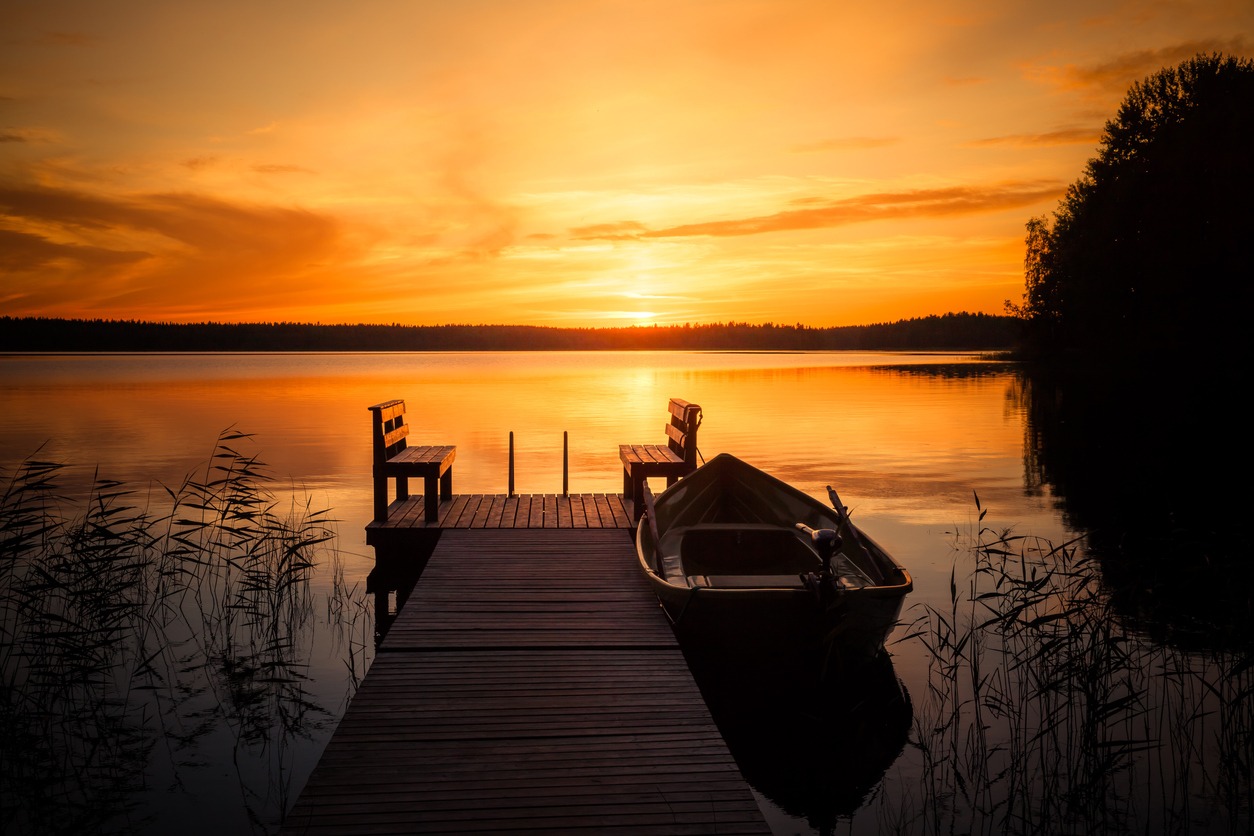 Sunset over the fishing pier at the lake in rural Finland
