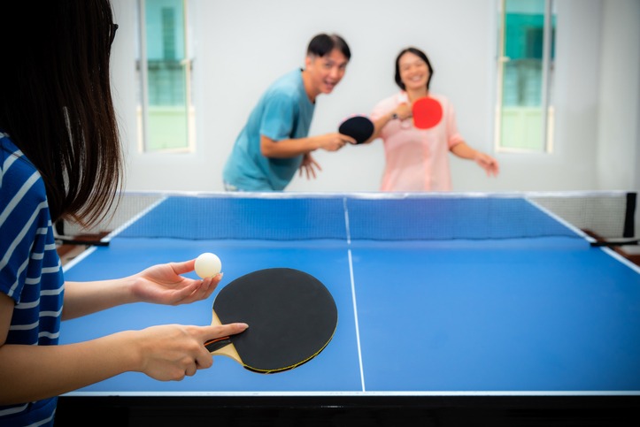 Asian family fun playing table tennis stay at home