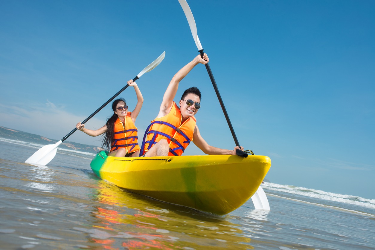 two couples paddling a kayak