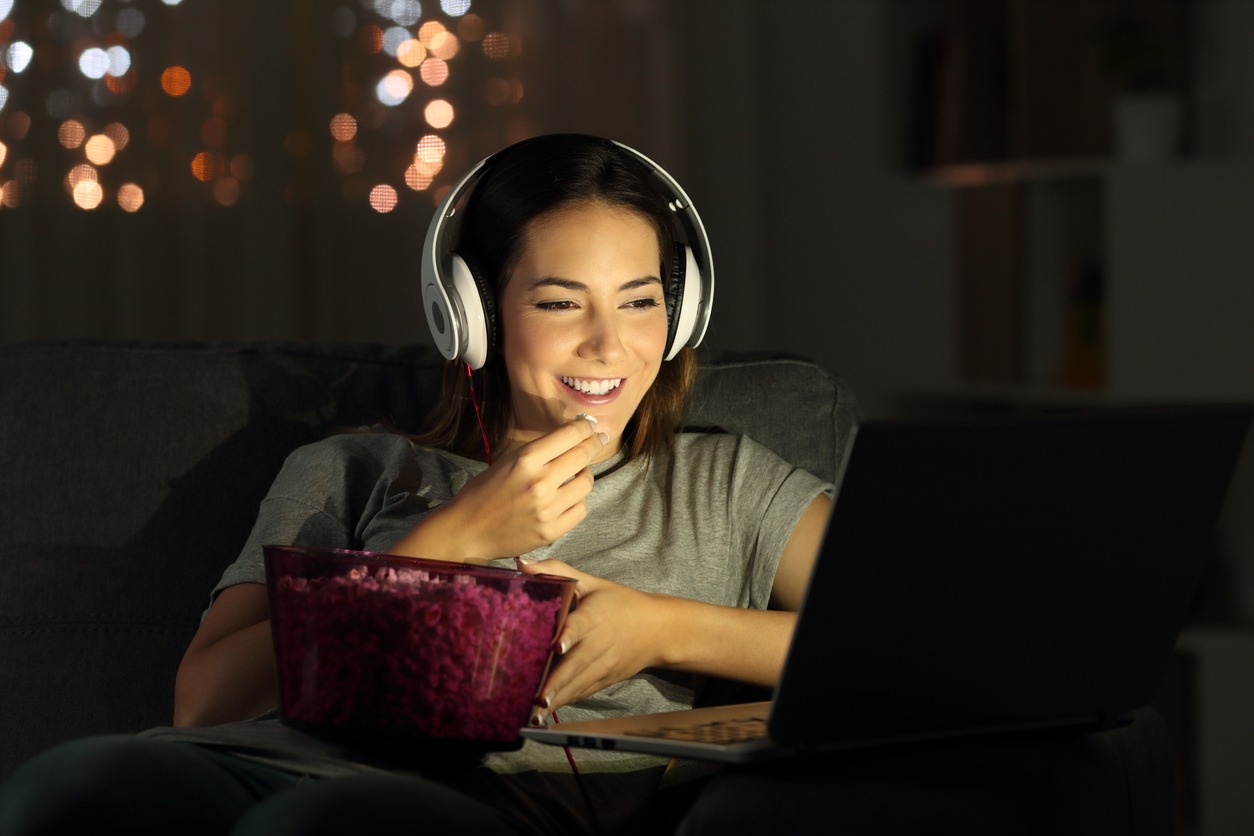 woman watching a movie at home