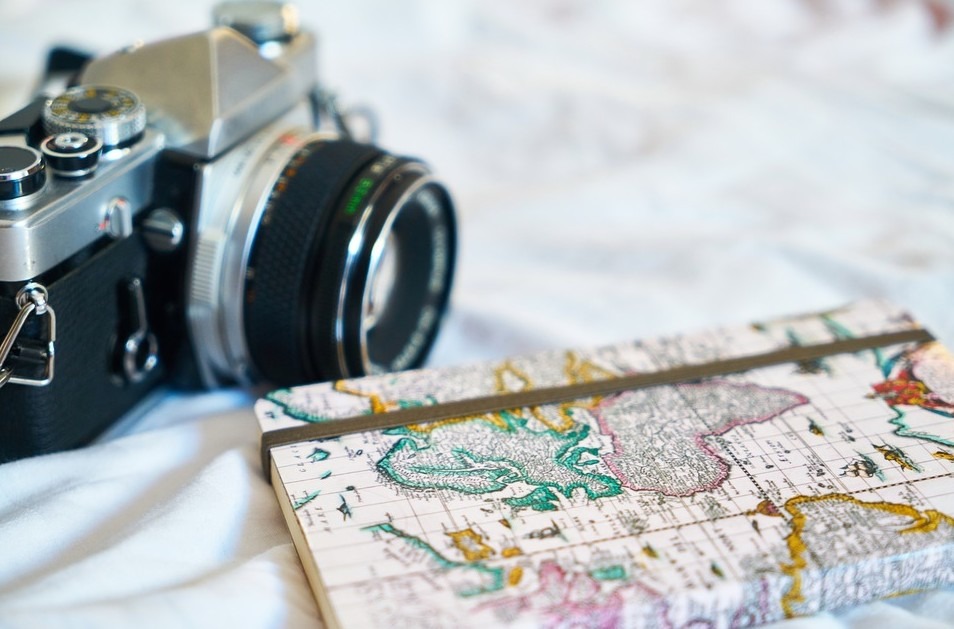 A camera and a journal with a map