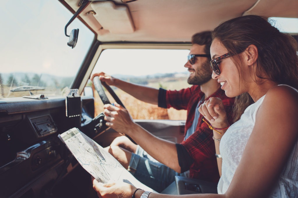 A couple using a map on a roadtrip