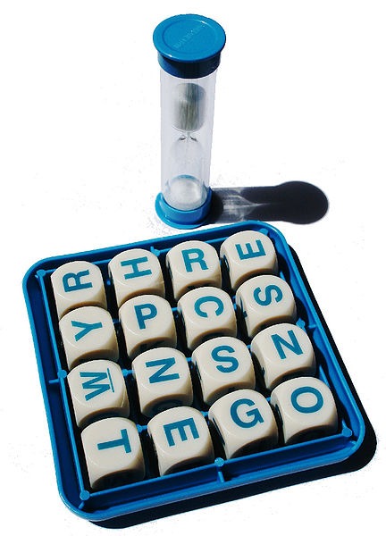 A grid of Boggle cubes and a sand timer
