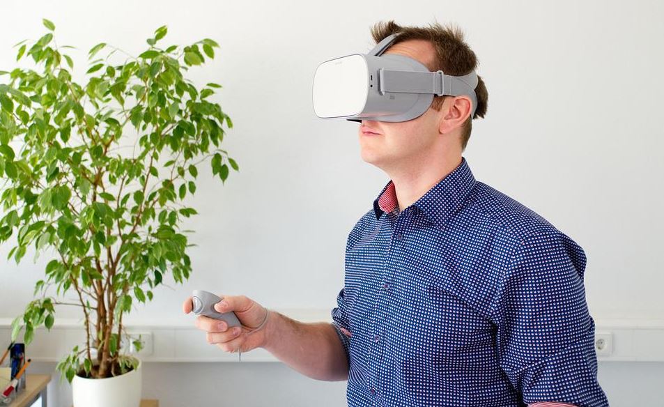 A man using VR goggles at home
