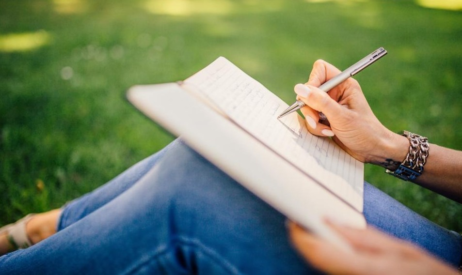 A person journaling outdoors