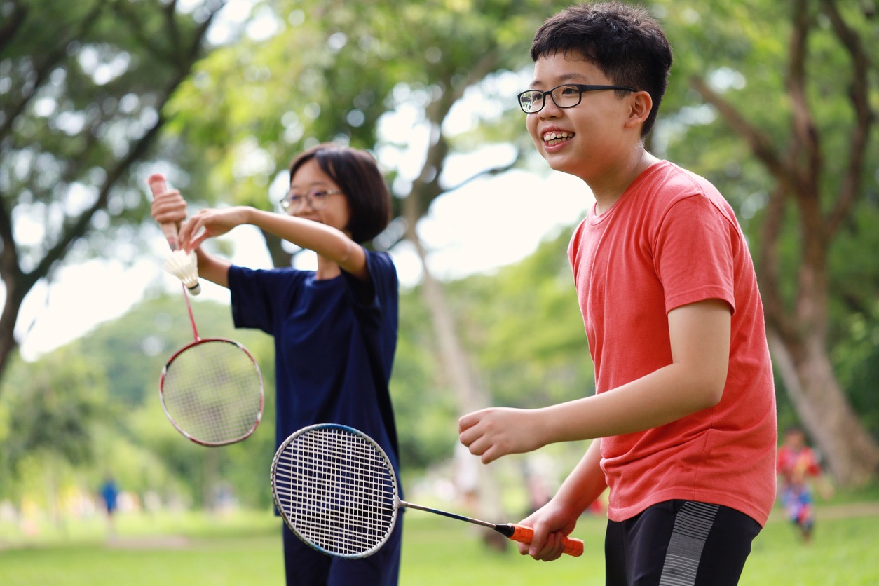 Boy and girl playing badminton