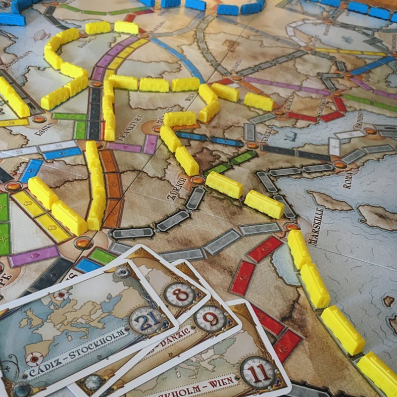 Close-up photo of trains and Destination Ticket cards on Ticket to Ride Europe board game