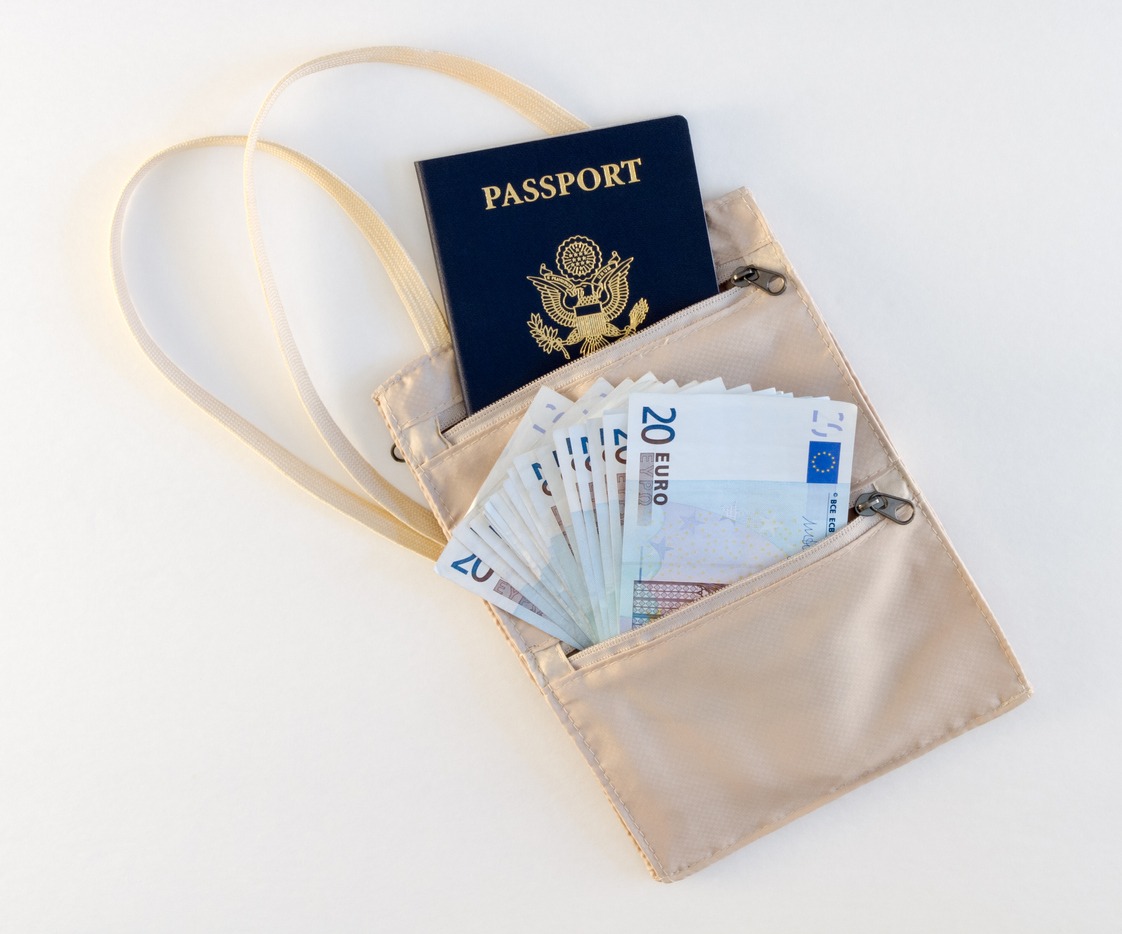 Passport and euros in a travel neck pouch