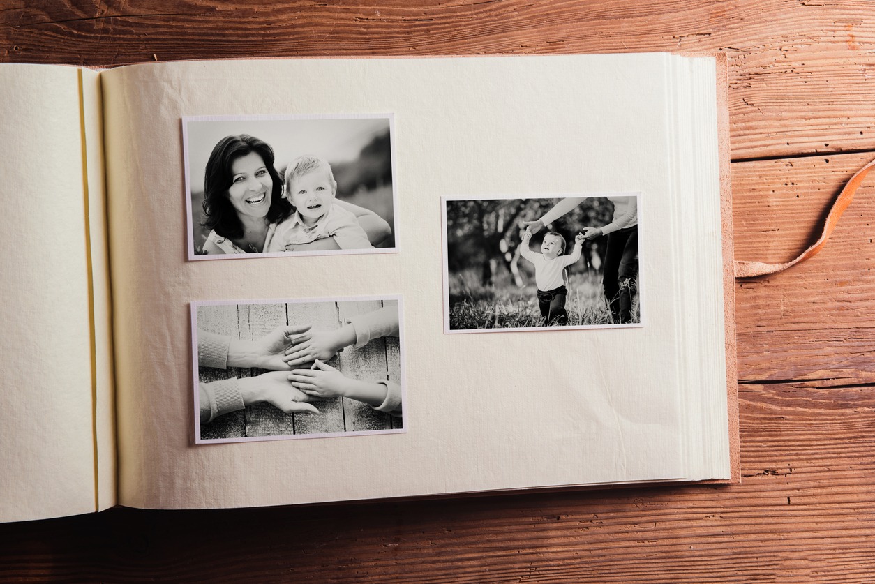 Photo album photographs that were taken against a wooden background in black and white
