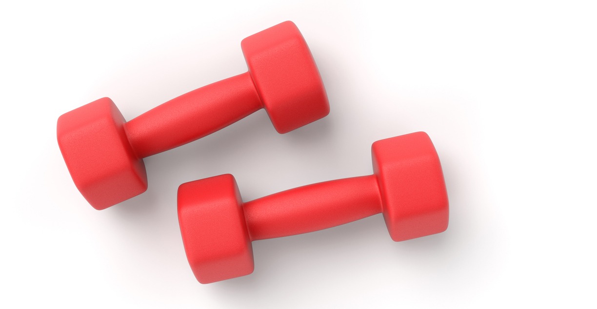 Two red fitness dumbbells with rubber or plastic coatings are isolated on a white background.