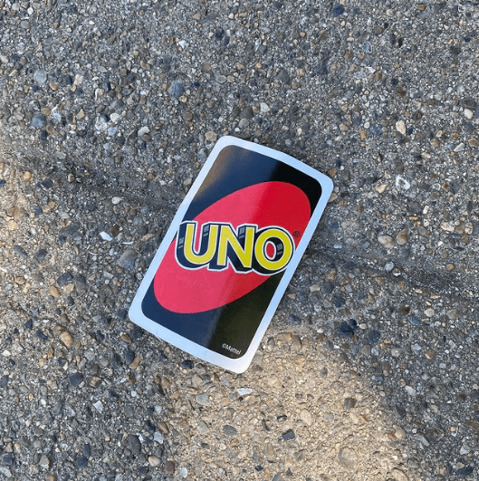 Uno card on a road