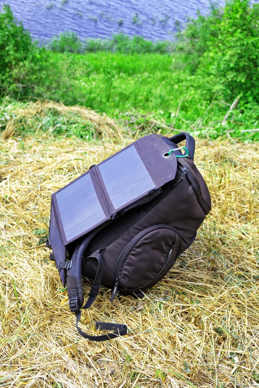 Compact solar panel is attached to the backpack for charging gadgets outdoor