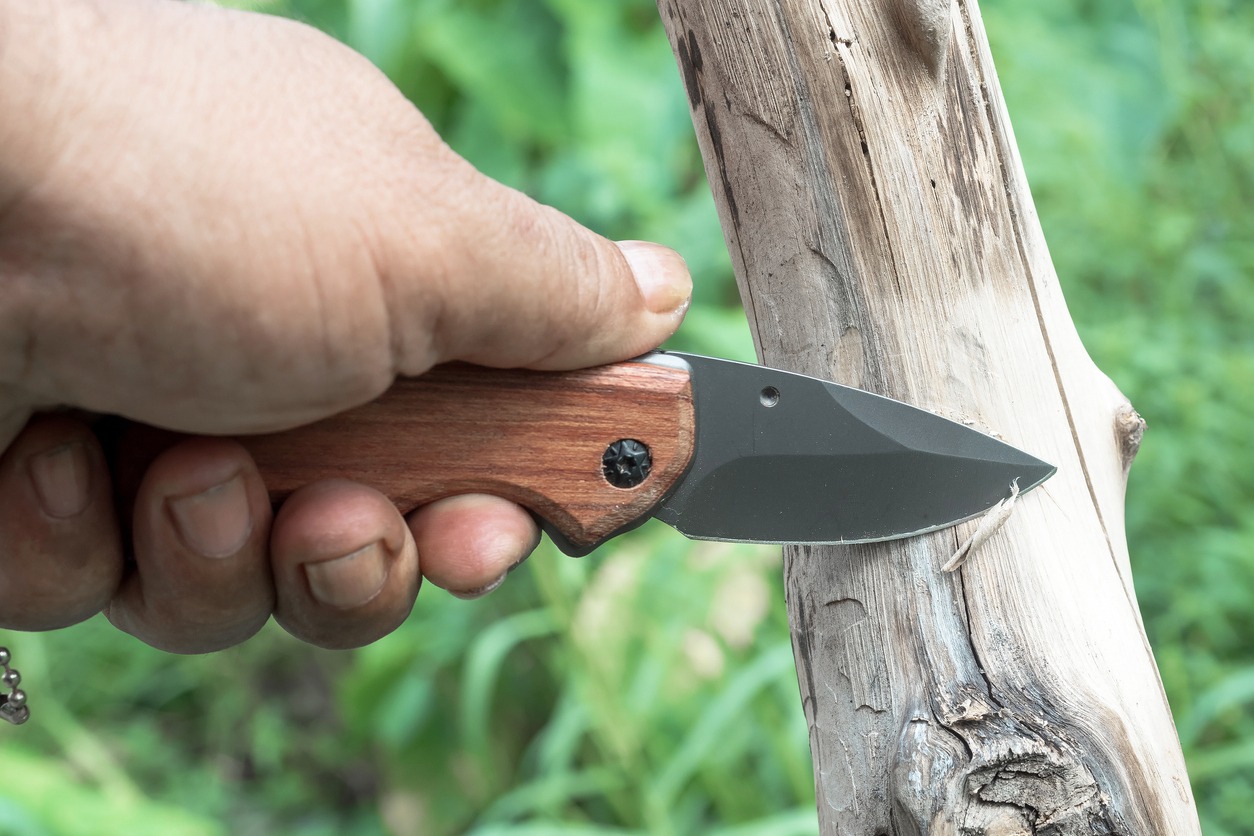 Scrape the wood surface with a folding knife