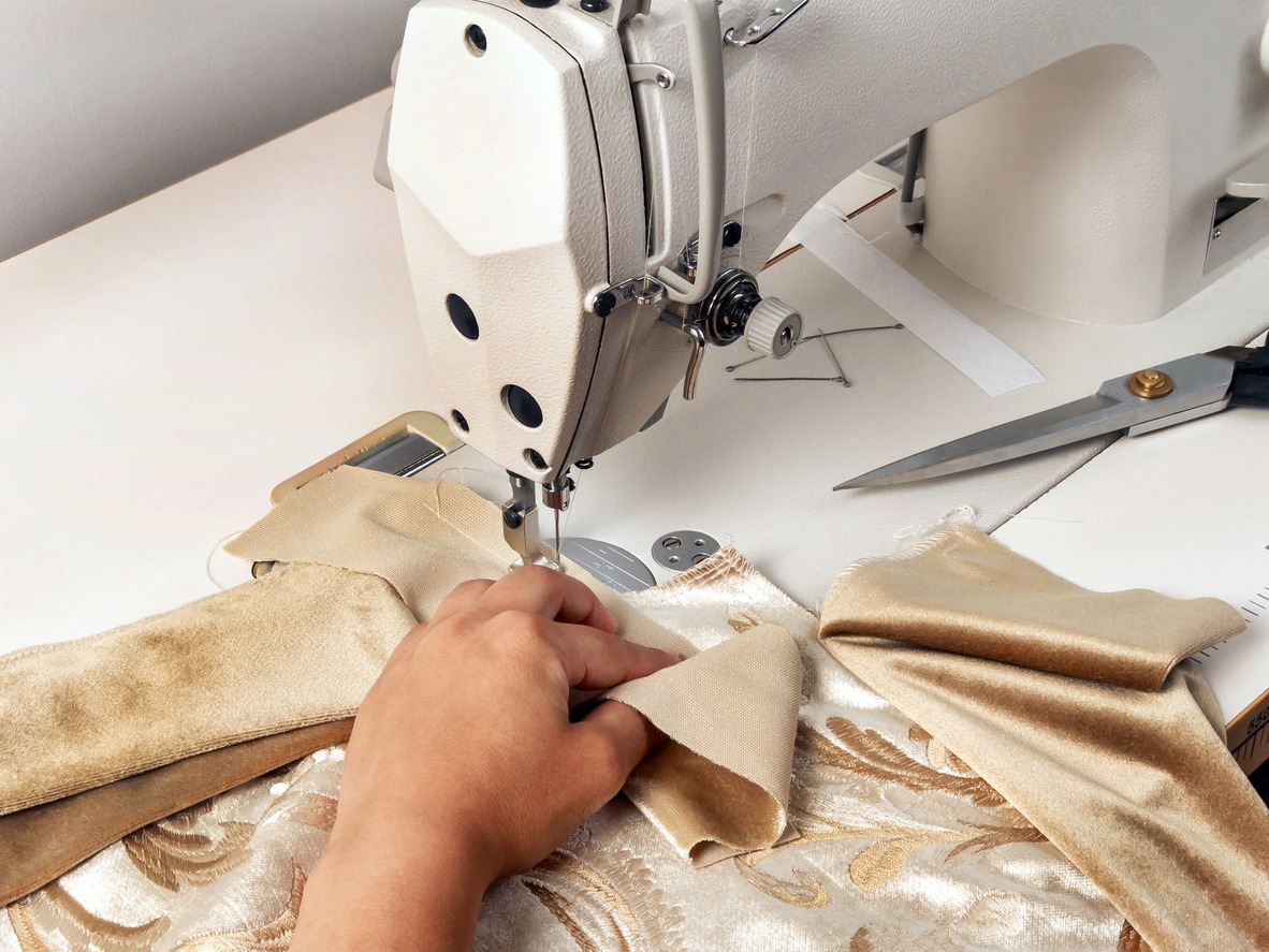 Seamstress workspace, sewing machine, piece of fabric
