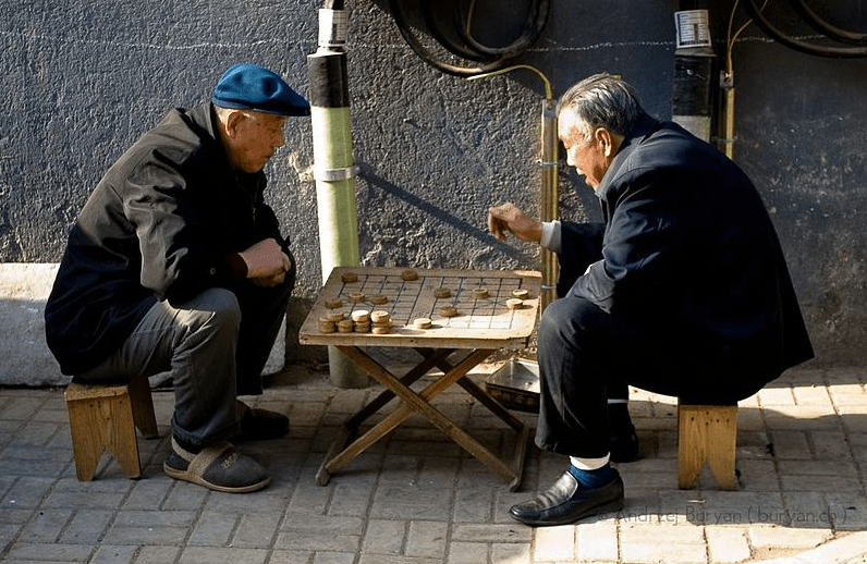 two-older-adults-playing-a-board-game-