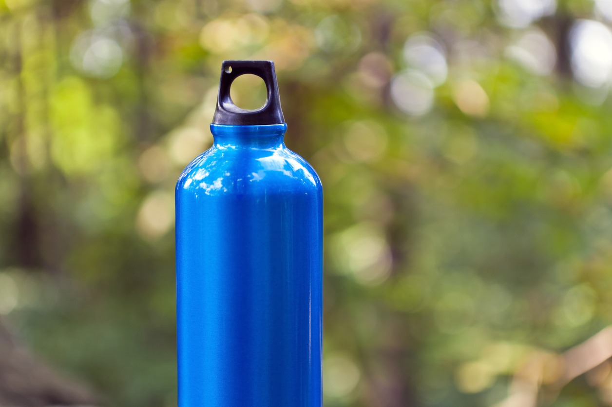 Water bottle in green forest