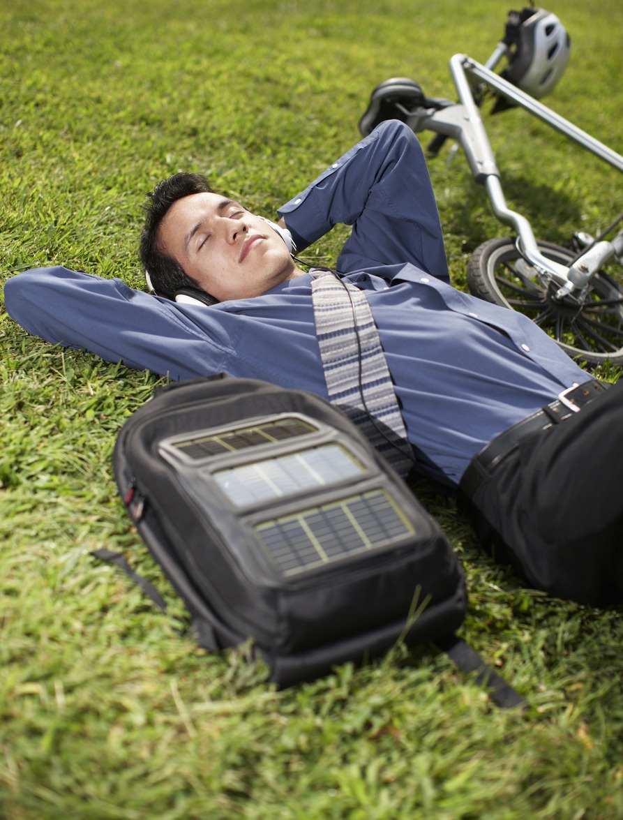 Young Businessman with Bicycle Lying on Grass