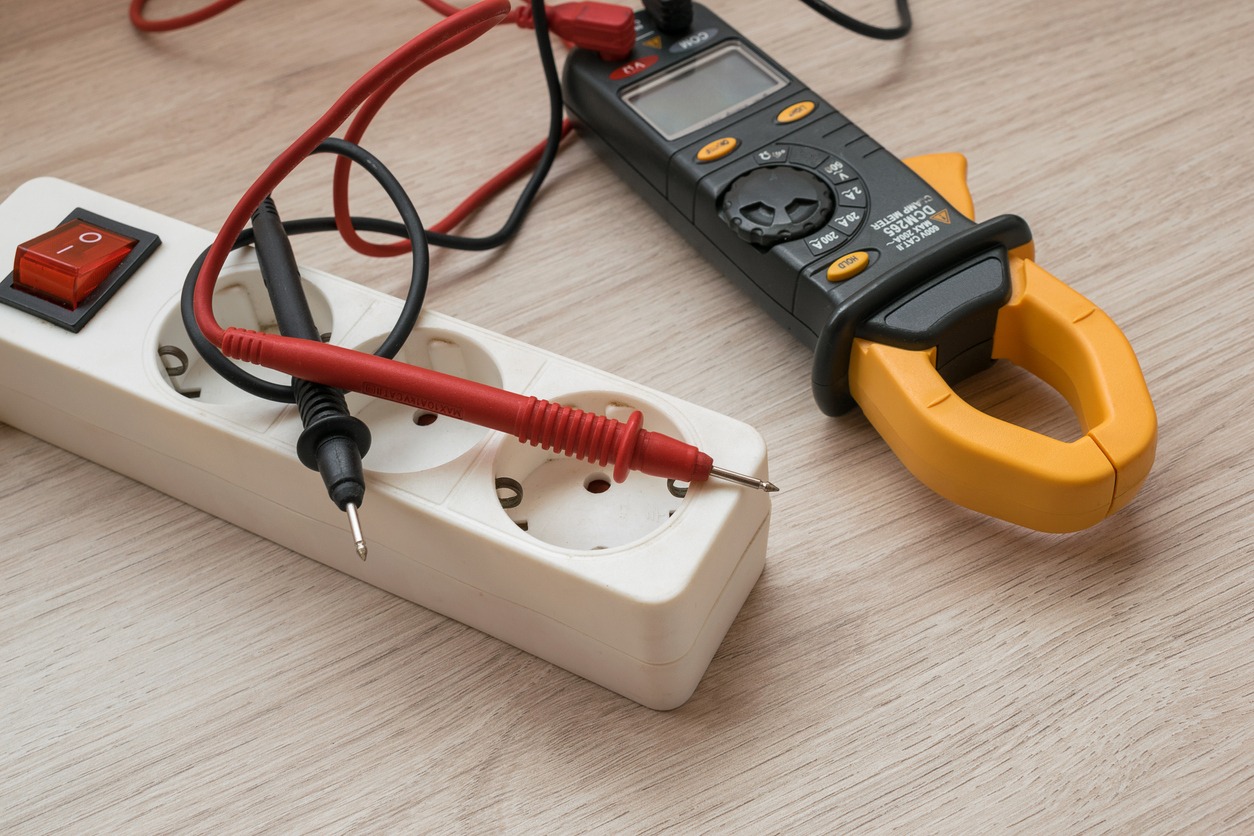 A clamp meter with a power strip