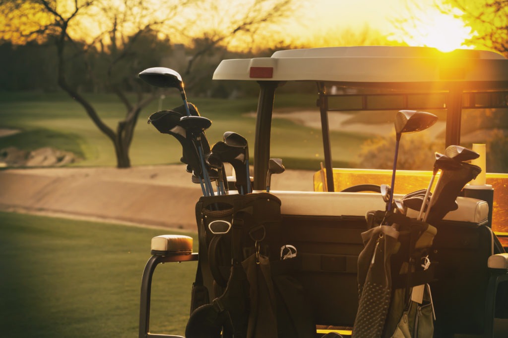 Golf cart - beautiful sunset overlooking gold course