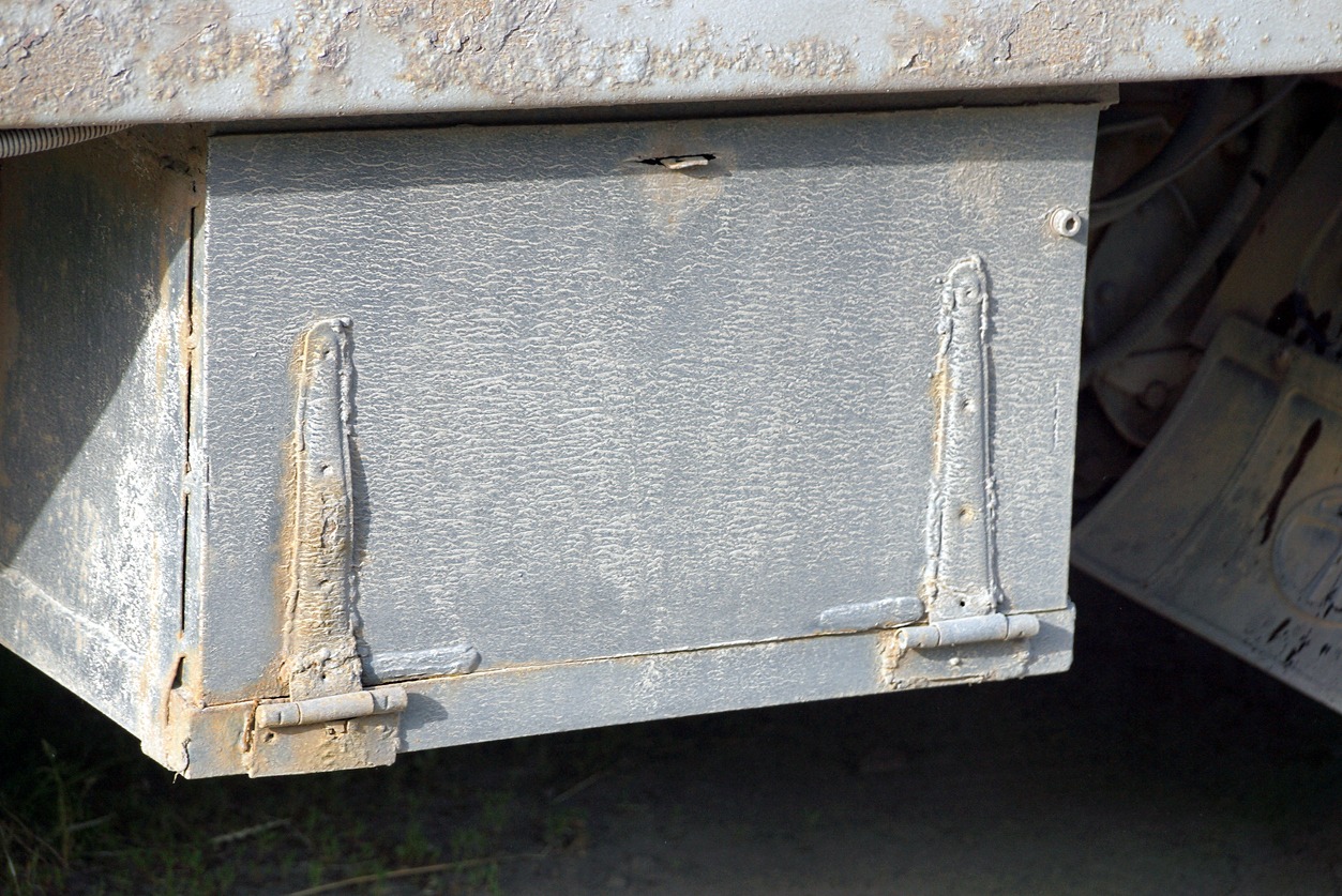 metallic toolbox hanging under a truck bed