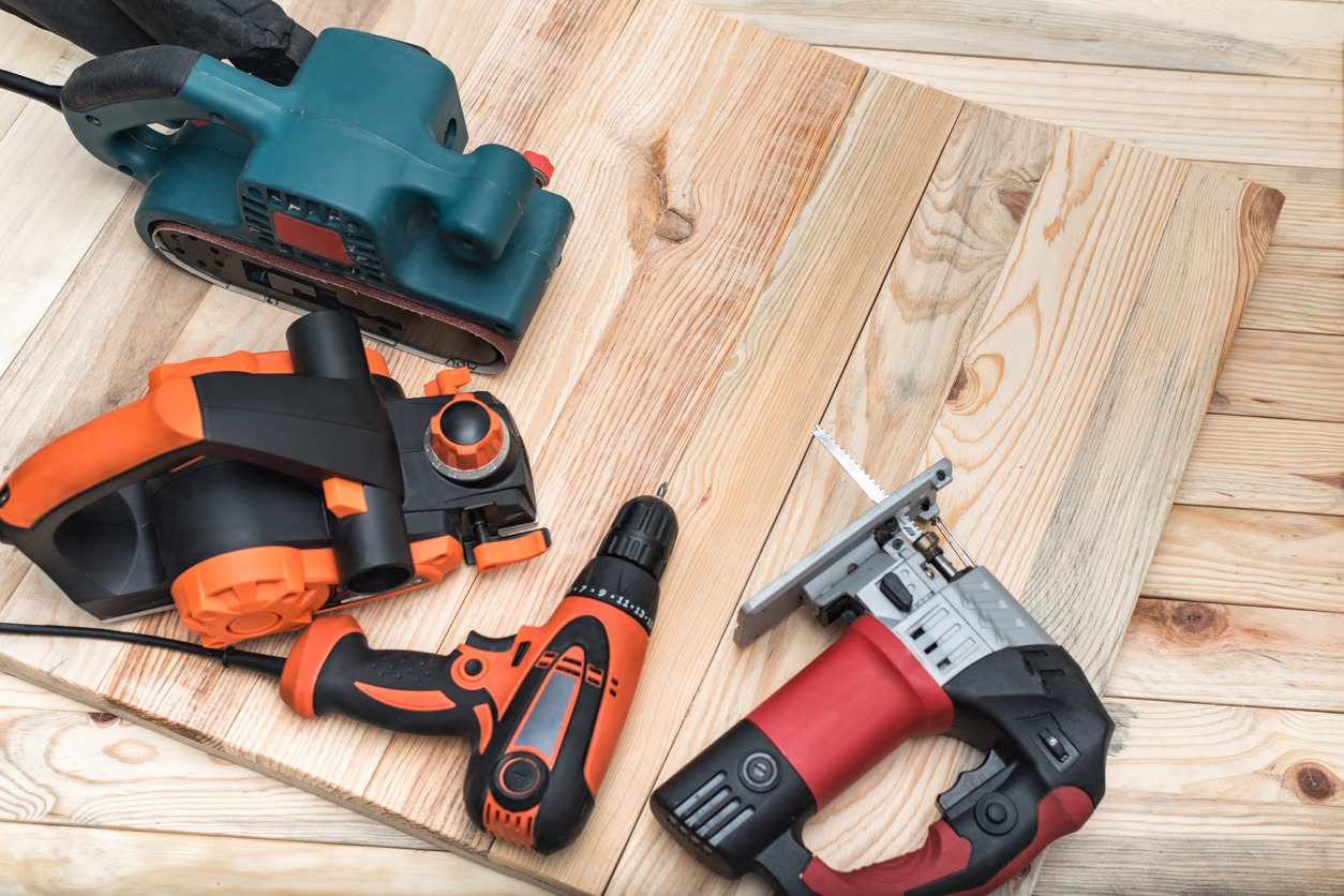 various power tools on a wooden surface