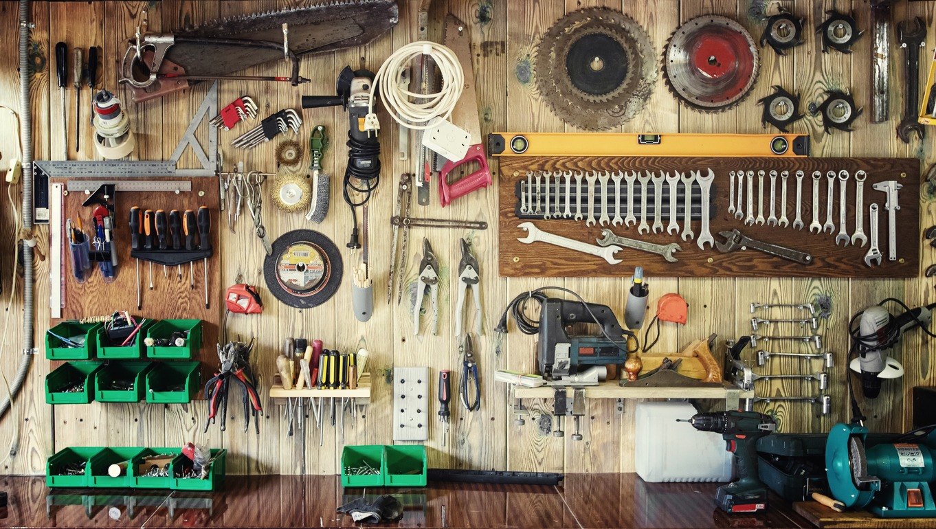 wall-mounted toolbox with many tools