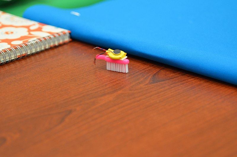 A DIY bristlebot placed on a desk