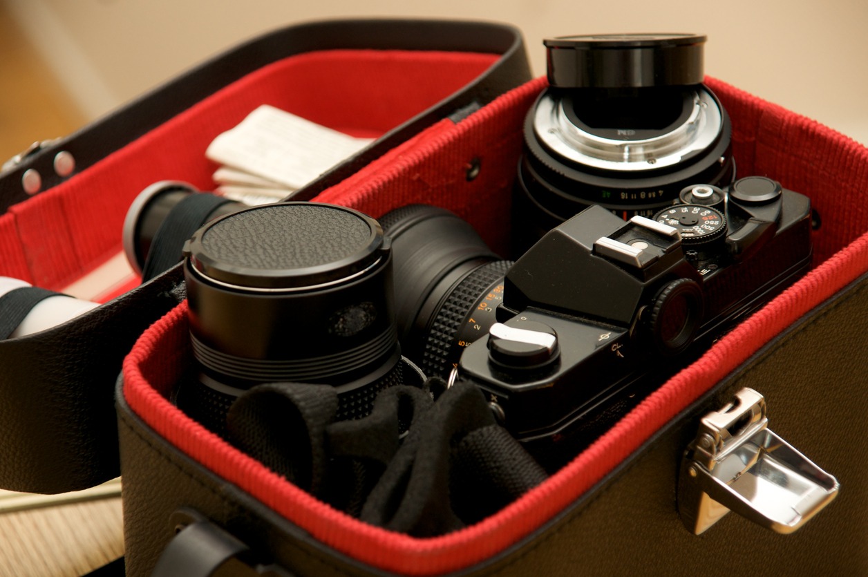 A camera and lenses arranged in a camera bag